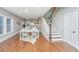 Open dining area with white table set, hardwood floors and stairs leading to the second floor at 2130 Weaver St, Charleston, SC 29403