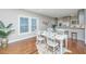 Bright dining room with hardwood floors features a decorative table set with blue accents, next to the open kitchen at 2130 Weaver St, Charleston, SC 29403
