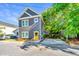 Charming two-story home with gray siding, white trim, yellow front door, and parking pad at 2130 Weaver St, Charleston, SC 29403