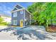 Charming two-story home featuring a gray exterior, yellow door, and a spacious driveway with landscaped surroundings at 2130 Weaver St, Charleston, SC 29403
