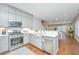 Bright kitchen featuring stainless steel appliances, grey cabinets, and an open layout to the dining and living areas at 2130 Weaver St, Charleston, SC 29403