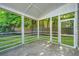 A screened porch with views of a green lawn is perfect for outdoor relaxation and enjoying the scenery at 2130 Weaver St, Charleston, SC 29403