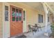 Inviting entryway with orange door, glass panels, chairs, and views of the exterior at 2150 Spoleto Ln # B-11, North Charleston, SC 29406