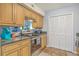 Updated kitchen with stainless steel range, tile backsplash, and wooden cabinets at 2150 Spoleto Ln # B-11, North Charleston, SC 29406