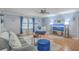 Bright living room with blue walls, hardwood floors, a comfy sofa, and natural light at 2150 Spoleto Ln # B-11, North Charleston, SC 29406