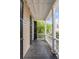This inviting balcony has black shutters, white trim, and wood flooring, perfect for enjoying outdoor living at 23 Savage St, Charleston, SC 29401