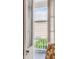 A charming balcony with white railings offers a glimpse of the neighborhood through open, shuttered windows at 23 Savage St, Charleston, SC 29401