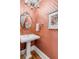 Charming powder room featuring patterned wallpaper, an ornate mirror, and a decorative crystal chandelier at 23 Savage St, Charleston, SC 29401