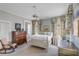 Sunlit bedroom showcasing fine furnishings, including a painted dresser and a cozy rocking chair at 23 Savage St, Charleston, SC 29401