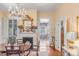 Beautiful dining room with a fireplace and an open view to the library at 23 Savage St, Charleston, SC 29401
