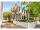 Charming two-story home with a inviting porch, white picket fence and a well manicured lawn at 23 Savage St, Charleston, SC 29401