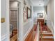 Inviting hallway adorned with hardwood floors and decorative art leading to a bedroom with stylish décor at 23 Savage St, Charleston, SC 29401