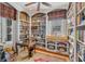 Charming library with custom bookshelves, a cozy window seat, and a ceiling fan at 23 Savage St, Charleston, SC 29401