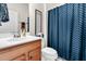 Bright bathroom featuring a wood vanity, chevron shower curtain, and framed wall art at 239 Sea Lavender Ln, Summerville, SC 29486