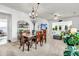 Open concept dining room with wood table, chandelier, and view into living room and backyard at 239 Sea Lavender Ln, Summerville, SC 29486