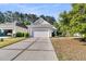 Home with two car garage and well maintained lawn at 239 Sea Lavender Ln, Summerville, SC 29486