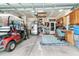Well-organized garage featuring a golf cart, refrigerator, and storage solutions for organized living at 239 Sea Lavender Ln, Summerville, SC 29486