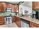 Well-lit kitchen with stainless appliances, granite countertops, and wood cabinets at 239 Sea Lavender Ln, Summerville, SC 29486