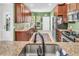 Spacious kitchen featuring granite countertops, wood cabinetry, and stainless steel appliances at 239 Sea Lavender Ln, Summerville, SC 29486