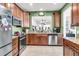 Eat-in kitchen with stainless steel appliances, granite countertops, and view into dining area at 239 Sea Lavender Ln, Summerville, SC 29486