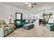 Inviting living room featuring a green sofa, striped armchair, ceiling fan, and carpeted floors at 239 Sea Lavender Ln, Summerville, SC 29486