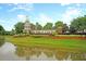 Community entrance sign reflecting in the pond at Del Webb at Cane Bay at 239 Sea Lavender Ln, Summerville, SC 29486