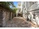 Brick lined backyard with an outdoor seating area and architectural details of the house at 24 Chalmers St, Charleston, SC 29401