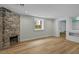 Finished basement with decorative brick fireplace and updated flooring at 24 Chalmers St, Charleston, SC 29401