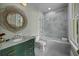Stunning bathroom featuring marbled glass-enclosed shower and green vanity at 24 Chalmers St, Charleston, SC 29401
