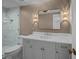 Bathroom with stylish vanity, marble counters, elegant lighting, and a glass-enclosed shower at 24 Chalmers St, Charleston, SC 29401