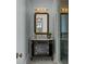 Elegant bathroom with black vanity, marble countertop, and a framed mirror at 24 Chalmers St, Charleston, SC 29401