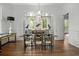Bright dining room boasts hardwood floors, modern light fixtures, and a view into the gourmet kitchen at 24 Chalmers St, Charleston, SC 29401