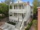 Stately two-story home with inviting balconies, meticulous landscaping, and elegant facade at 24 Chalmers St, Charleston, SC 29401