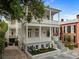 Elegant exterior of a two-story home with double balconies and meticulously landscaped yard at 24 Chalmers St, Charleston, SC 29401