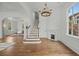 Bright foyer featuring hardwood floors, elegant staircase, fireplace, and arched doorways, exuding sophistication and charm at 24 Chalmers St, Charleston, SC 29401