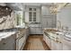 Luxury kitchen with marble countertops, high-end appliances, designer cabinets, and brass accents at 24 Chalmers St, Charleston, SC 29401