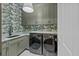 Well-organized laundry room with modern washer and dryer, complemented by stylish wallpaper at 24 Chalmers St, Charleston, SC 29401