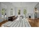 Stylish living room with high ceilings, large windows, fireplace, and chic furnishings creating an inviting space for relaxation at 24 Chalmers St, Charleston, SC 29401