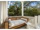 Relaxing porch area featuring a daybed and a side table, perfect for enjoying the outdoors at 24 Chalmers St, Charleston, SC 29401