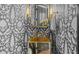 Chic powder room with unique wallpaper, a stylish mirror, and designer fixtures creating a sophisticated and functional space at 24 Chalmers St, Charleston, SC 29401