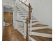 Elegant staircase with wood treads, white risers, and decorative wood banister at 24 Chalmers St, Charleston, SC 29401