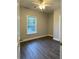 This bedroom is bright with hardwood floors and a window for natural light at 250 Dandelion Ct, Round O, SC 29474