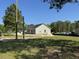 Exterior view of a home with a partially cleared lot and various construction equipment at 250 Dandelion Ct, Round O, SC 29474