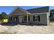 Inviting one-story home with a covered front porch and classic black shutters at 250 Dandelion Ct, Round O, SC 29474