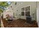 Well-maintained backyard patio with a grill, shade, privacy fence, and external air conditioning unit at 2505 Stadium Dr, North Charleston, SC 29406