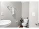 Half bath featuring a modern toilet, pedestal sink, and decorative wall accents at 2505 Stadium Dr, North Charleston, SC 29406