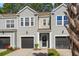 Townhome with a front yard, garage, and walkway leading to the front door at 2505 Stadium Dr, North Charleston, SC 29406