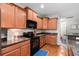 Well-lit kitchen featuring wood cabinets, modern black appliances, and stunning countertop finishes at 2505 Stadium Dr, North Charleston, SC 29406