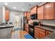 Modern kitchen featuring stainless steel appliances, wood cabinets, and granite countertops at 2505 Stadium Dr, North Charleston, SC 29406