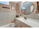 Bathroom with a modern vanity, a beige tiled floor and walls, and a large circular mirror at 2506 Birkenhead Dr, Charleston, SC 29414
